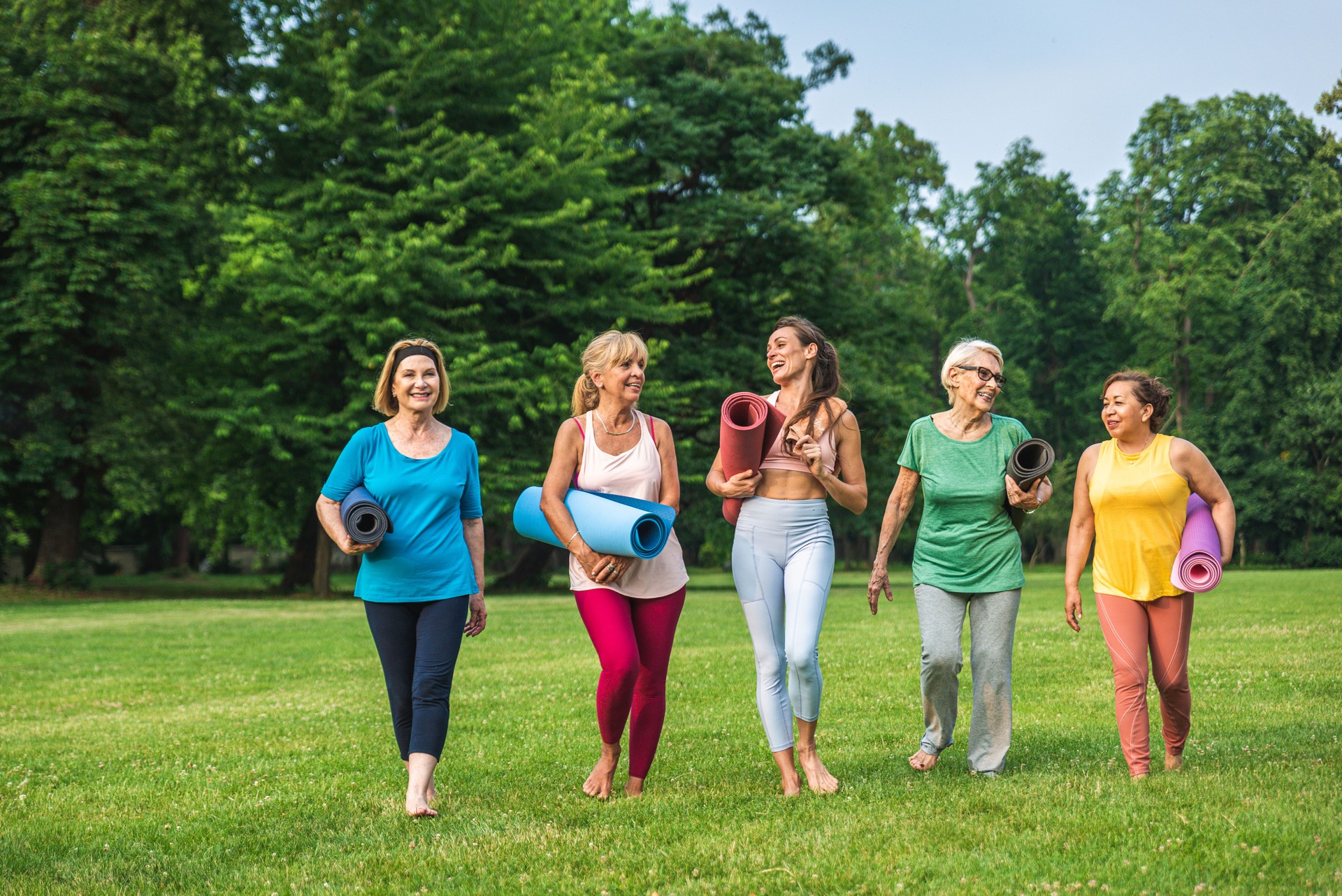 Mulheres seniores treinando com treinador de fitness no parque